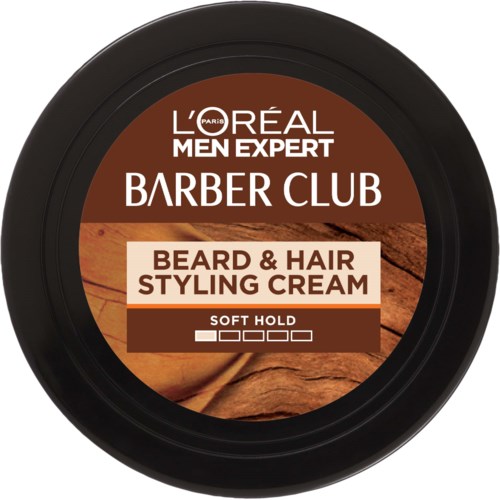 A round container of L'Oréal Men Expert Beard & Hair Styling Cream with a brown label and wooden background.