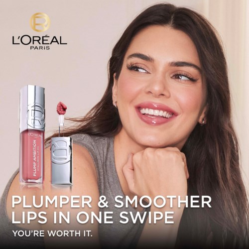 A woman smiling, looking to the side, with lips glossy, promoting L'Oréal lip products, logo, and text about smoother lips.