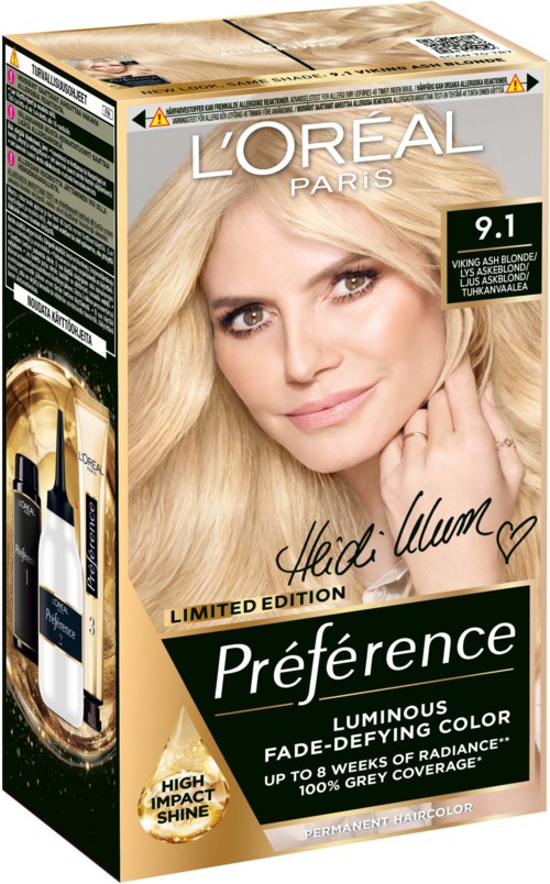 Eine Haarfärbekarton mit einem lächelnden Frauenkopf, L'Oréal-Logo und Produktdetails wie Farbton und Vorteilen.