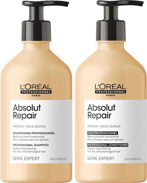 Zwei beige Flaschen L'Oréal-Shampoo mit schwarzen Pumpköpfen, markiert 'Absolut Repair' für geschädigtes Haar, 500 ml.