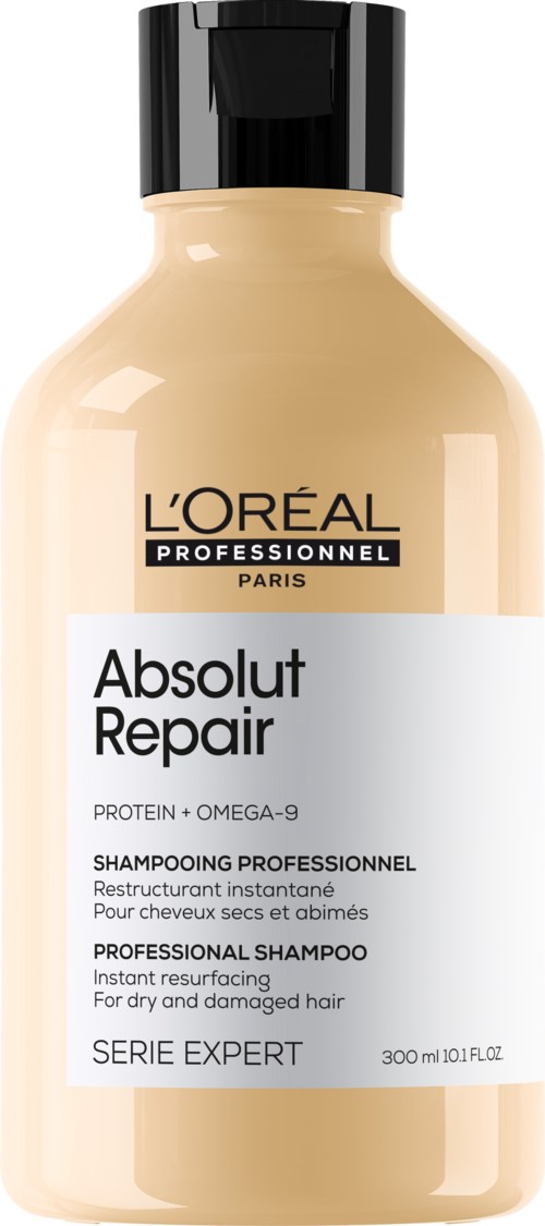 A beige bottle with a black cap, labeled L'Oréal Professionnel Absolut Repair shampoo.