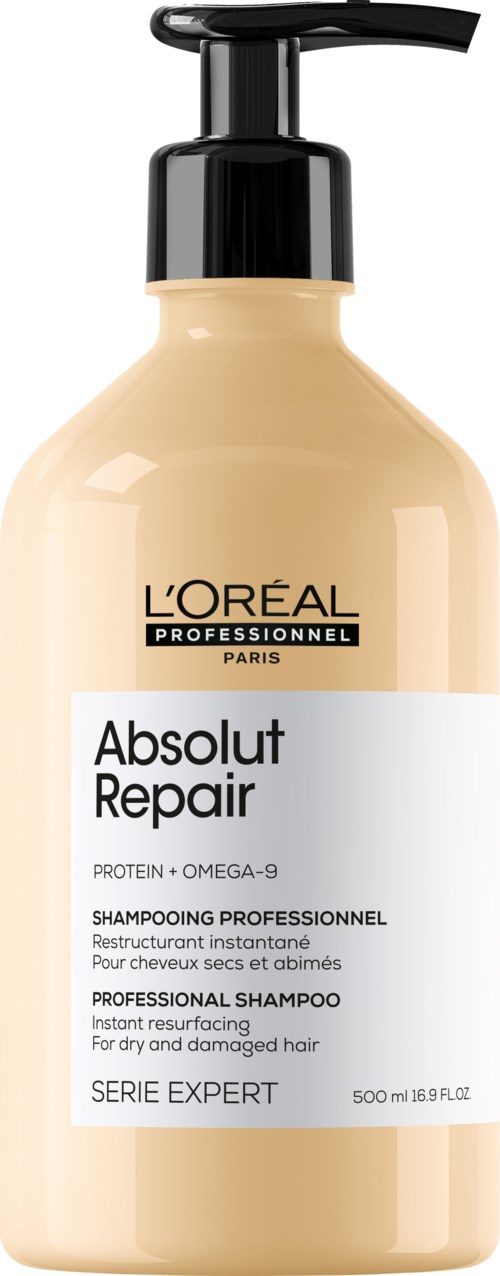 Een beige fles met zwarte pomp, gelabeld L'Oréal Absolut Repair shampoo voor beschadigd haar.
