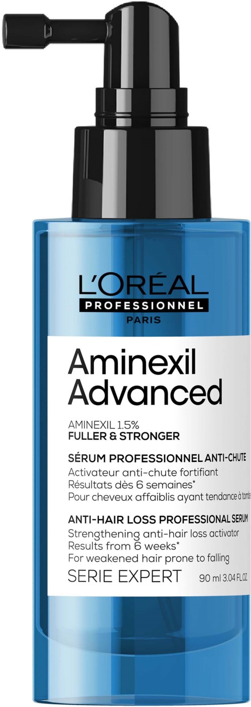 Sininen pullo pumpulla, merkattu L'Oreal Aminexil Advanced -hiustenlähtöseerumi. Sisältää 90 ml.