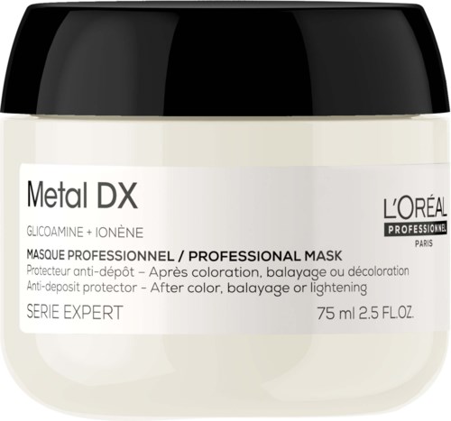 En burk med L'Oréal Metal DX professionell hårmask, med vit kräm, för efter färgning eller ljusning.