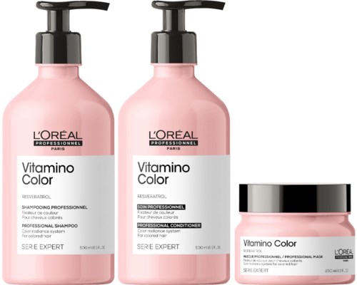 Drei rosa Behälter mit Haarpflegeprodukten: zwei Flaschen und ein Dose, beschriftet L'Oréal Vitamino Color.