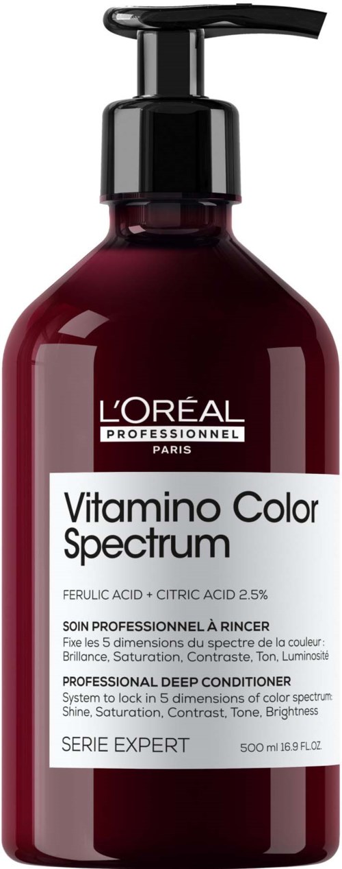 A dark red bottle with a black pump, labeled 'L'Oreal Professionnel Color Spectrum' for hair coloring.