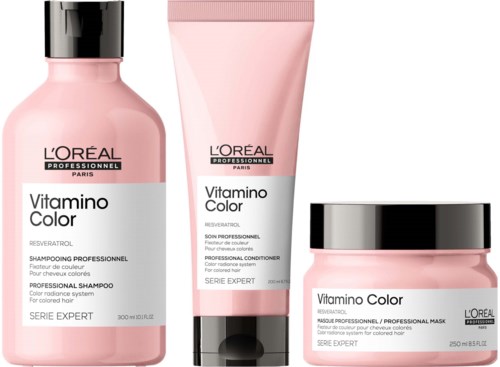 Drei pinke Haarpflegeprodukte aus L'Oréal Vitamino Color Serie mit schwarzen Deckeln und Etiketten.