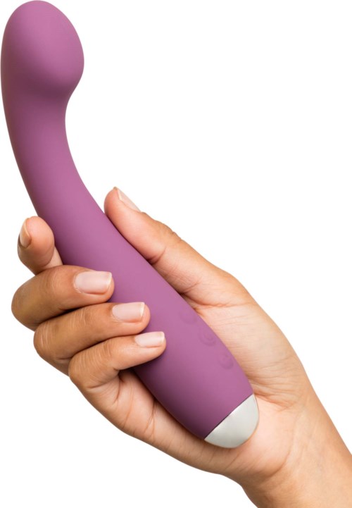 Eine Hand hält ein lilanes, gebogenes, langes Objekt mit runder Spitze und weißem Boden.