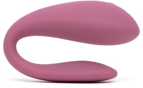 Ein rosa, gebogener, glatter Gegenstand, der wie ein modernes Massage- oder Entspannungsgerät aussieht.