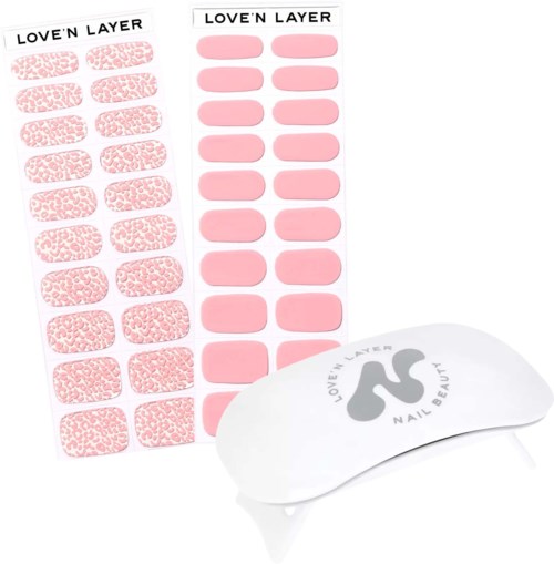 Sticker sheets with nail designs labeled "Love'n Layer." One sheet has leopard print, the other has solid pink. Nail patch tool included.