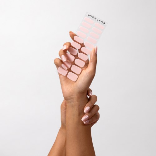 A hand holds a pink nail sticker sheet with the label "Loven Layer" at the top.