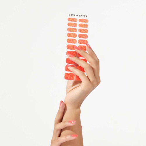 A hand holds an orange peel layer strip, labeled "Loven Layer," appearing textured and organized vertically.