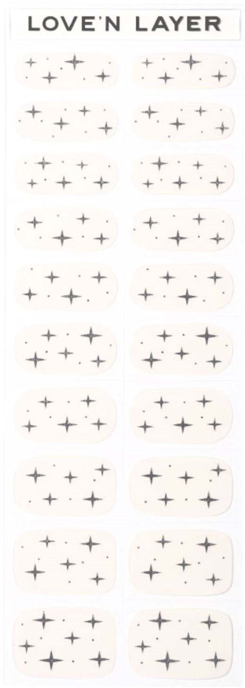 A sheet of nail stickers called 'Love 'N Layer' with various small black star patterns and rounded shapes.