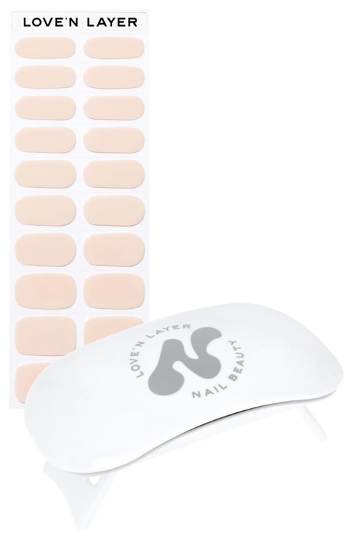 A set of beige nail stickers and a white nail care device with a logo. The stickers are arranged in rows.