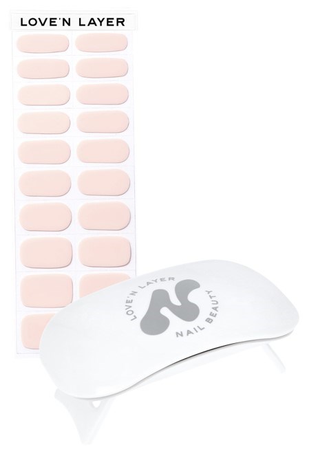 A nail care set with pink nail patches and a curved device, labeled 'LOVE'N LAYER' and 'NAIL BEAUT'.