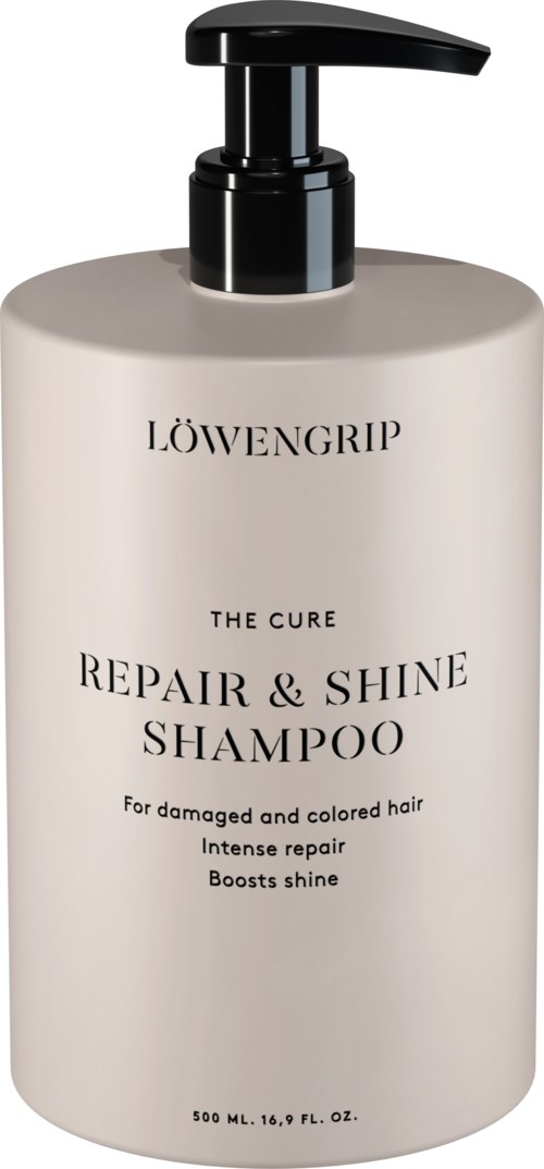 En stor vit flaska med svart pump märk med "LOWENGRIP THE CURE REPAIR & SHINE SHAMPOO" för skadat hår.