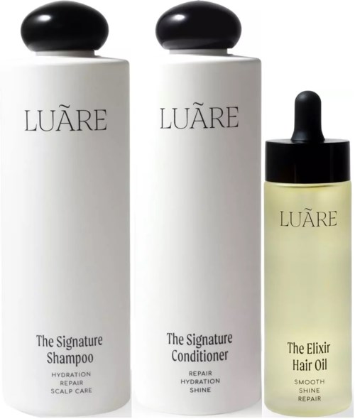 Drei Haarpflegeprodukte: zwei Shampooflaschen und einen Conditioner mit Pipette. Alle sind weiß mit schwarzen Deckeln und Etiketten.