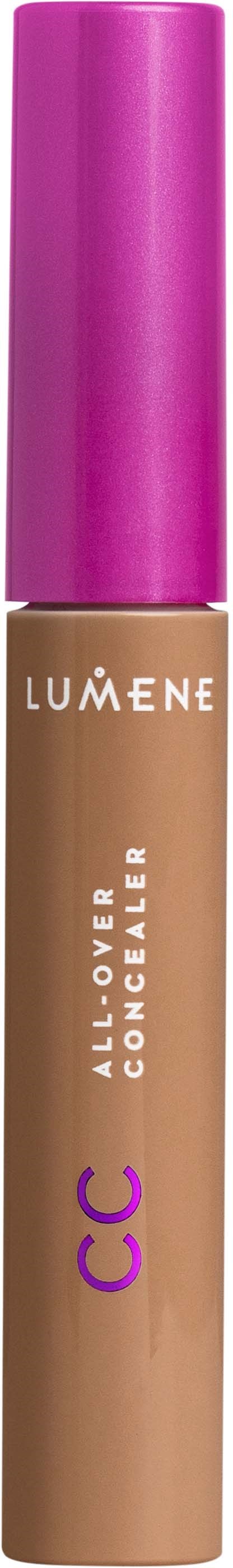 A concealer stick with a purple cap, beige body, and white and purple text on it.