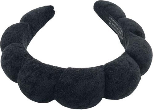 A black, plush, U-shaped pillow with large, soft segments, designed for neck support.