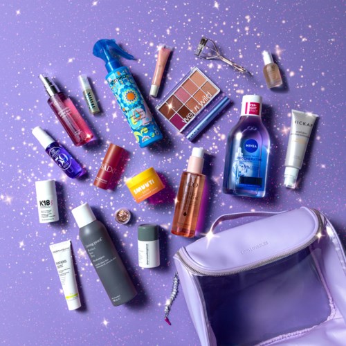 Beauty products, makeup, nail polish, skincare, and a purple bag on a purple starry background.