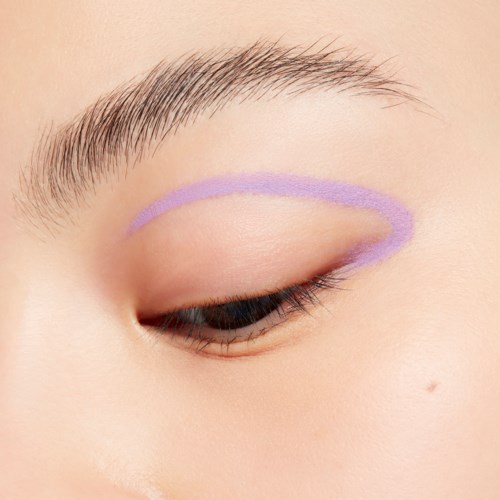 Close-up of a closed eye with a purple eyeliner guide on the eyelid.