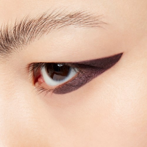 Close-up of an eye with black eyeliner and natural skin. Eyebrow and eyelashes are visible.