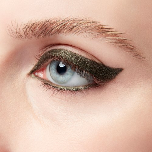 Close-up of a blue eye with dark eye makeup and defined eyebrow.