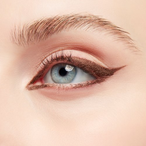 Close-up of a blue eye with makeup and long eyelashes. The eye has eyeliner and a hint of eye shadow.