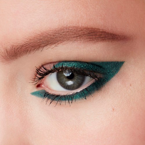 A close-up of an eye with teal and black eye makeup and long eyelashes.