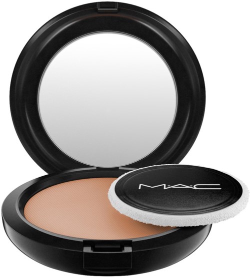 Black round container with mirror and beige powder. Included is a white sponge for application.