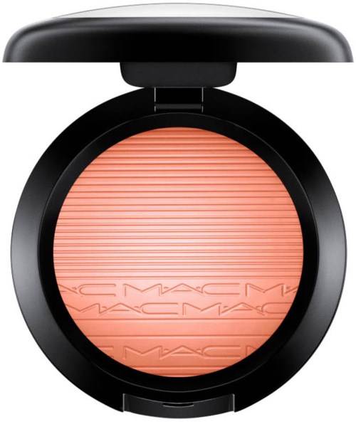 A round makeup blush compact with a coral-colored blush and a black lid.