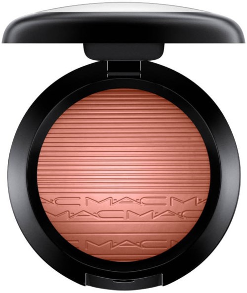 A round makeup blush compact with a pink powder inside and a black lid. The brand name MAC is embossed on the powder.