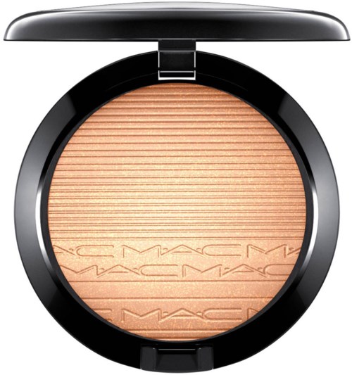 A makeup compact with pressed powder, black round case, and MAC logo on the powder surface.