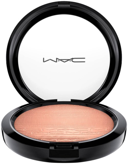 A black round makeup compact with a mirror and peach-colored blush inside. The brand MAC is on the mirror.