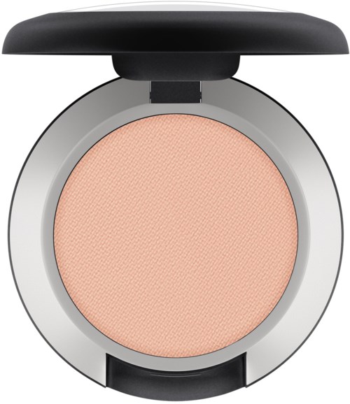 A round peach-colored makeup blush inside a silver compact with a black lid.