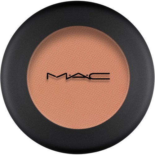 A round container of M.A.C. makeup with a peach-colored powder inside and a black border.