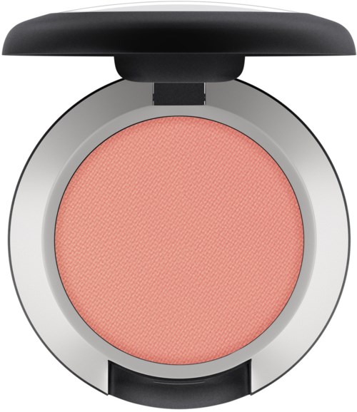 A round makeup blush with a peach color, in a silver compact case with a black lid.