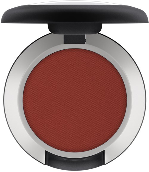 A round makeup compact with red blush inside and a black lid on top.
