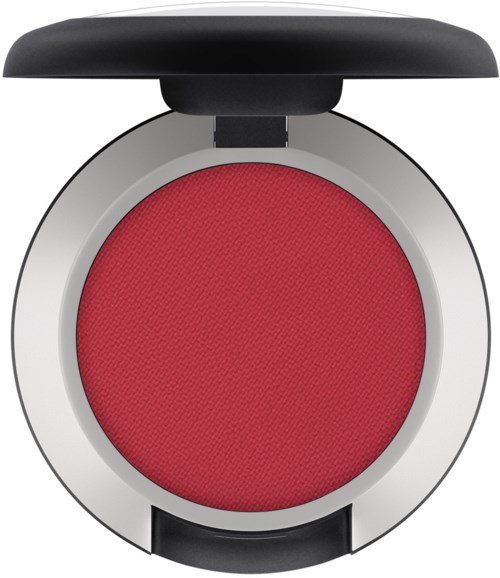 A round red makeup compact with a black lid open, showing the red powder inside.