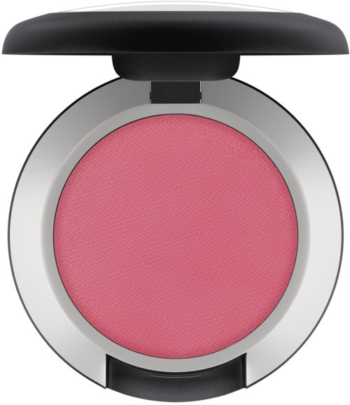 A round makeup compact with pink blush and a black cover on top.