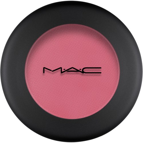 A pink blush inside a round black compact with the MAC logo on it.