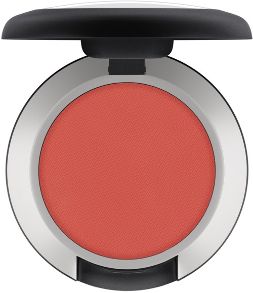 A coral-colored blush in a compact case with a black lid that is open.