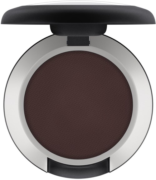 A circular makeup compact with dark brown powder and a black lid on top.