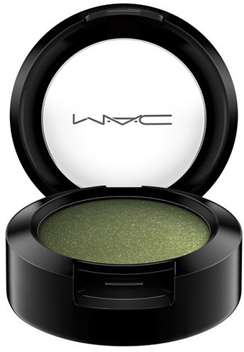 Green eyeshadow in a black round container with a clear lid, branded MAC, open showing the makeup inside.