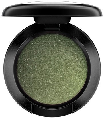 A green eyeshadow in a black round compact with a lid open.