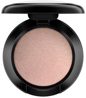 A round makeup compact with a light pink, shimmery powder inside and a black lid on top.