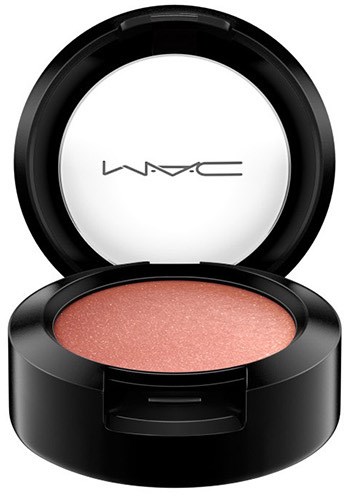 A round orange-pink blush inside a black compact case with a mirror. MAC logo on the inside of the lid.