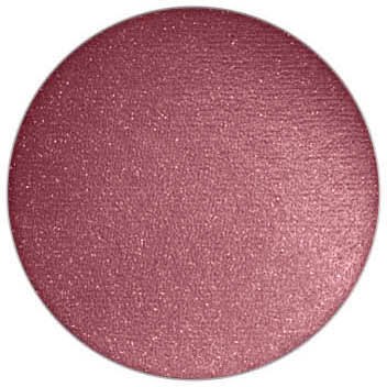 En rosa, glitterig rund sak med en glänsande yta som glittrar.