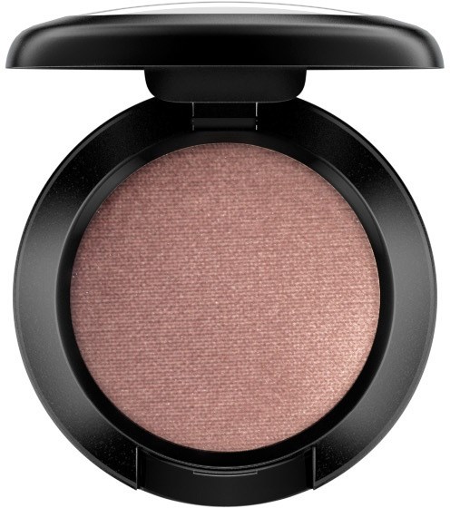 A round makeup compact with pinkish eyeshadow inside and a black lid open.