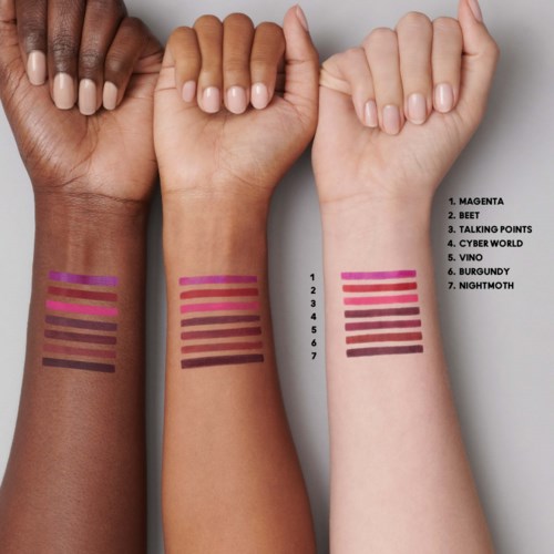 Three hands show different skin tones with colorful lines and names of colors on the forearms.